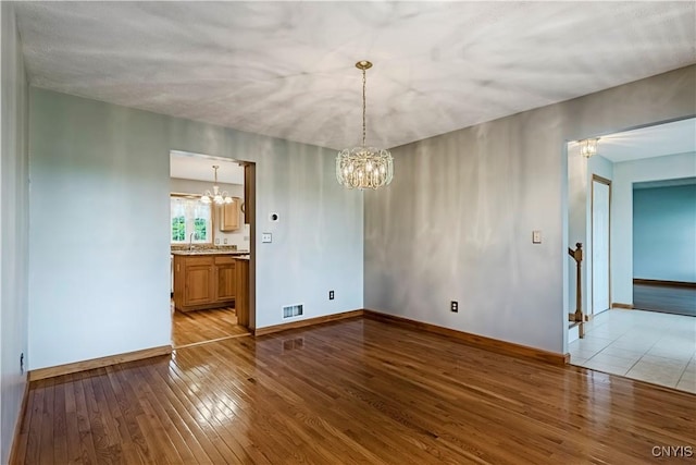 121 Ben Bar Cir, Whitestown, NY 13492 - empty room with a chandelier and hardwood / wood-style flooring