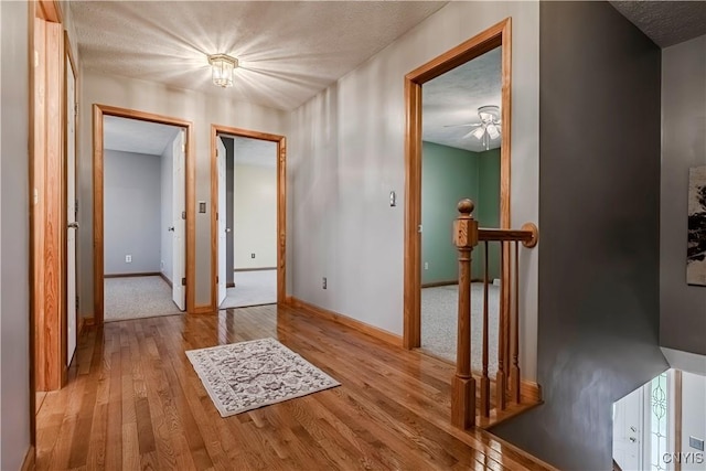 121 Ben Bar Cir, Whitestown, NY 13492 - hall with light wood-style flooring, an upstairs landing, and a textured ceiling