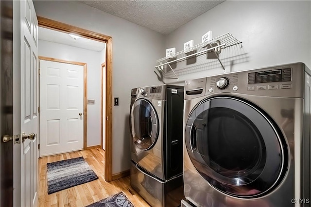 121 Ben Bar Cir, Whitestown, NY 13492 - laundry room with washing machine and dryer, light wood-style floors, and a textured ceiling