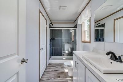 27634 County Route 342, Le Ray, NY 13612 - full bath featuring vanity, a shower with door, and wood finished floors