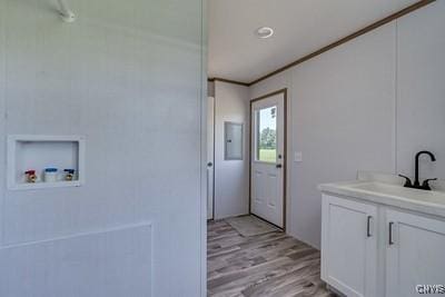 27634 County Route 342, Le Ray, NY 13612 - laundry room with light wood-style floors, ornamental molding, and washer hookup