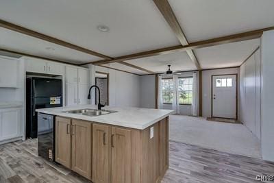 27634 County Route 342, Le Ray, NY 13612 - kitchen featuring black dishwasher, light wood-type flooring, beam ceiling, light countertops, and an island with sink