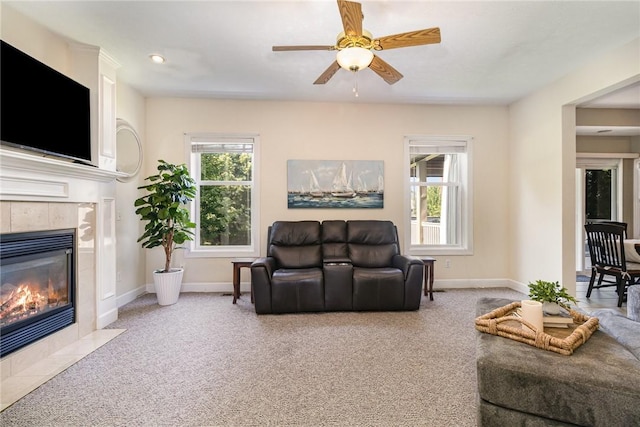 228 Southshore Pl, Webster, NY 14580 - living room featuring carpet, a tiled fireplace, and a ceiling fan