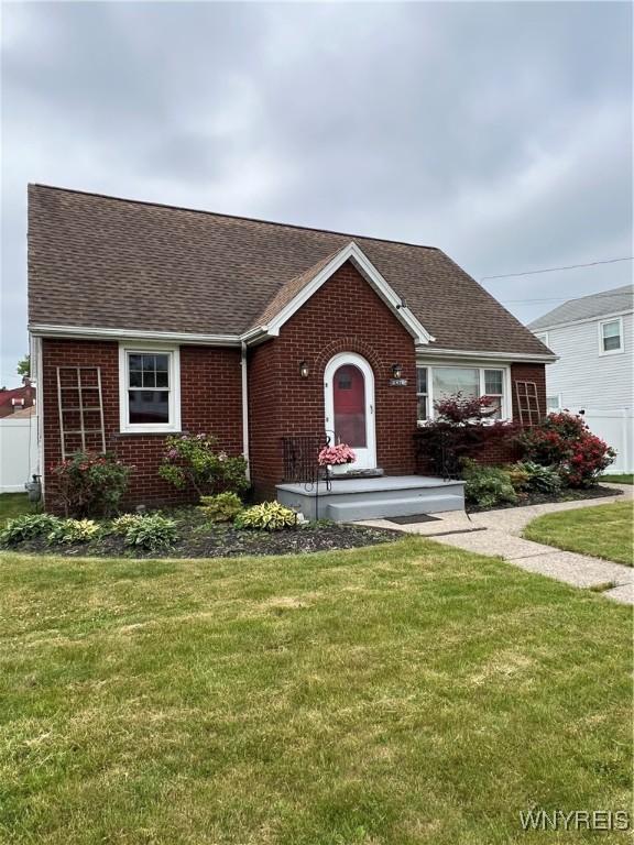2479 Forest Ave, Niagara Falls, NY 14301 - view of front of property featuring brick siding, roof with shingles, and a front yard