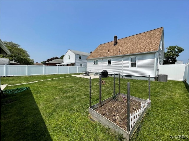 2479 Forest Ave, Niagara Falls, NY 14301 - rear view of house with a garden, a fenced backyard, a patio, a chimney, and a shingled roof