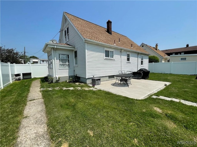 2479 Forest Ave, Niagara Falls, NY 14301 - rear view of house featuring a patio, a chimney, a fenced backyard, and a shingled roof