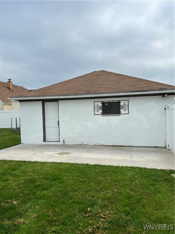 2479 Forest Ave, Niagara Falls, NY 14301 - back of property with a patio, roof with shingles, and concrete block siding