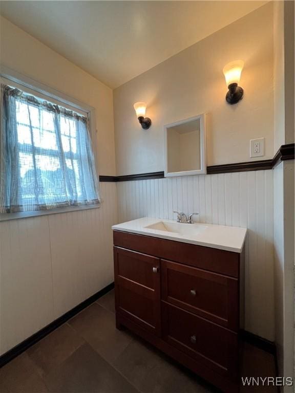 2479 Forest Ave, Niagara Falls, NY 14301 - bathroom featuring vanity, wainscoting, and tile patterned flooring