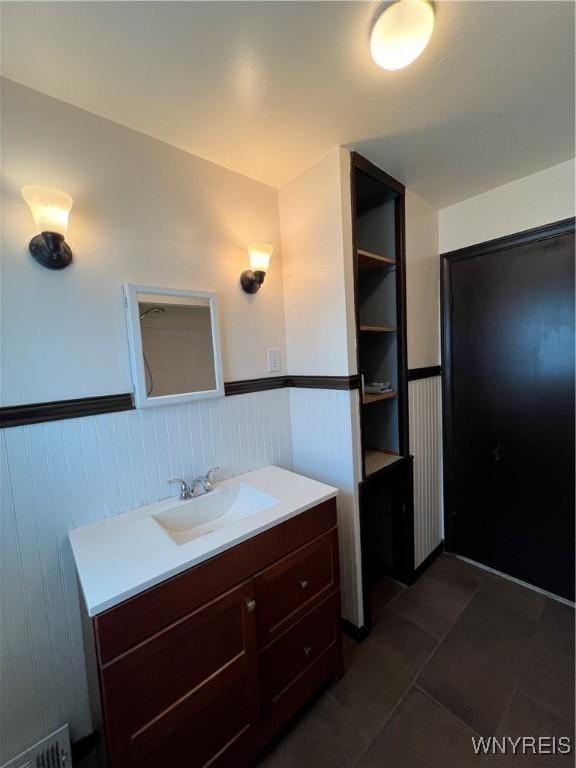 2479 Forest Ave, Niagara Falls, NY 14301 - bathroom with wainscoting, vanity, and tile patterned flooring
