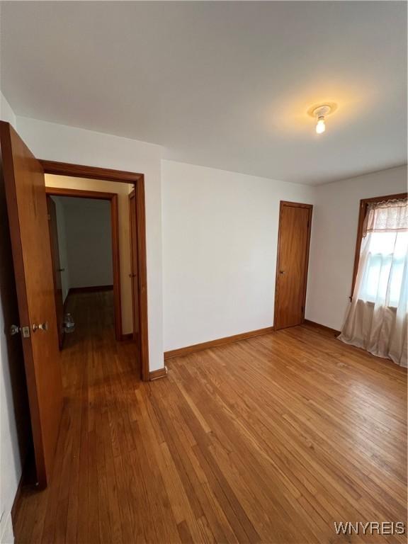 2479 Forest Ave, Niagara Falls, NY 14301 - unfurnished room with wood-type flooring and baseboards