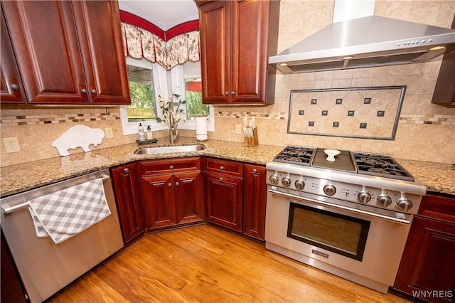 9 Rolling Woods Ln Unit E, West Seneca, NY 14224 - kitchen with stainless steel appliances, wall chimney exhaust hood, dark brown cabinets, light wood-style floors, and decorative backsplash