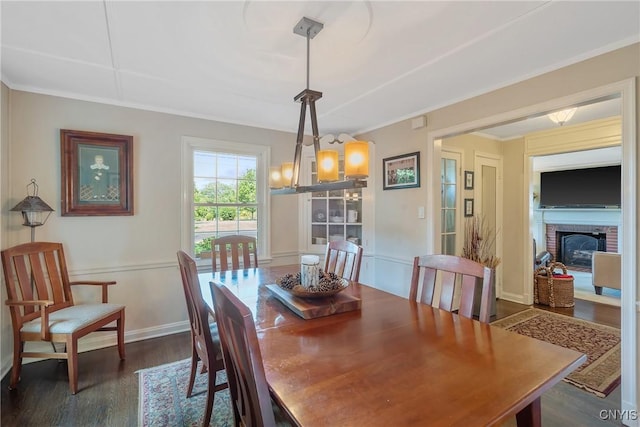 200 Halton Rd, Dewitt, NY 13224 - dining room with dark wood-type flooring, a brick fireplace, and crown molding