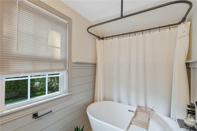 200 Halton Rd, Dewitt, NY 13224 - full bathroom featuring a freestanding bath, a shower with curtain, and wainscoting
