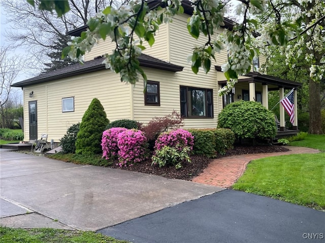 64 Bunner St, Oswego, NY 13126 - view of property exterior with a yard and a porch