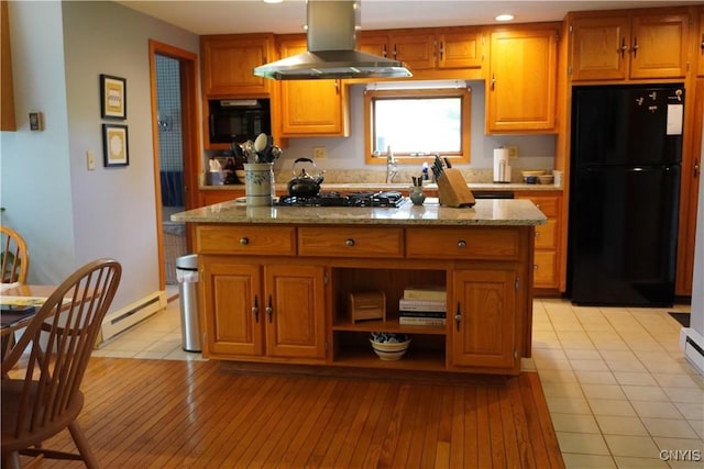 64 Bunner St, Oswego, NY 13126 - kitchen with black appliances, wall chimney exhaust hood, a baseboard radiator, a kitchen island, and recessed lighting