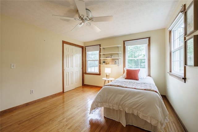 326 Cheese Factory Rd, Mendon, NY 14472 - bedroom featuring a textured ceiling, light wood-type flooring, a ceiling fan, and a closet
