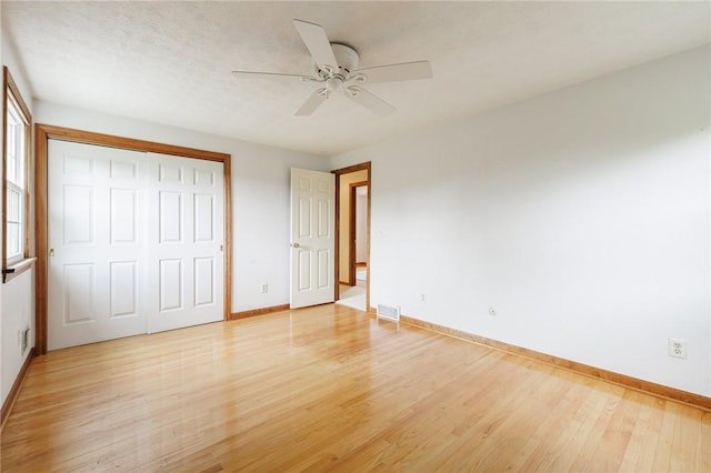 326 Cheese Factory Rd, Mendon, NY 14472 - unfurnished bedroom with light wood-type flooring, a closet, and ceiling fan