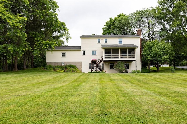 326 Cheese Factory Rd, Mendon, NY 14472 - rear view of house with a sunroom, a chimney, stairs, and a yard