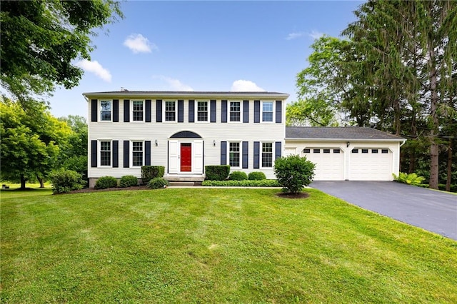 326 Cheese Factory Rd, Mendon, NY 14472 - colonial house featuring an attached garage, asphalt driveway, and a front lawn