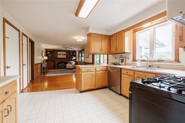 326 Cheese Factory Rd, Mendon, NY 14472 - kitchen with stainless steel dishwasher, a ceiling fan, open floor plan, black range with gas stovetop, and a peninsula