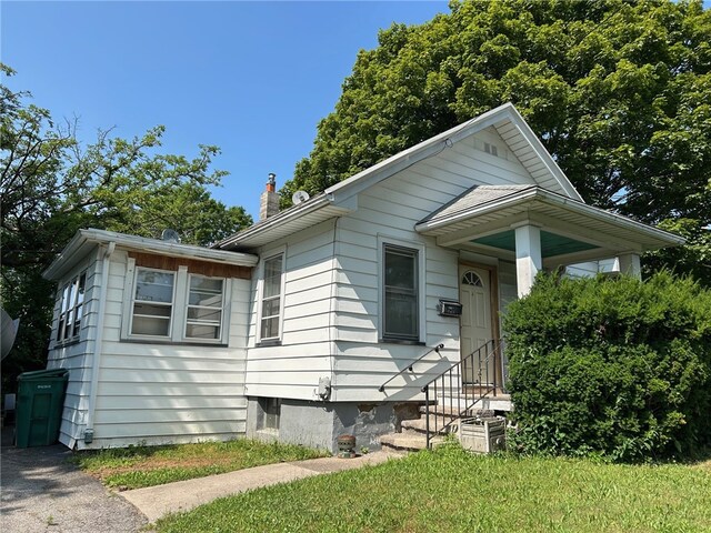 472 Seneca Rd, Irondequoit, NY 14622 - bungalow-style house with a chimney