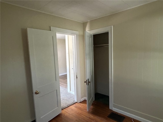 472 Seneca Rd, Irondequoit, NY 14622 - unfurnished bedroom with dark wood finished floors and a closet
