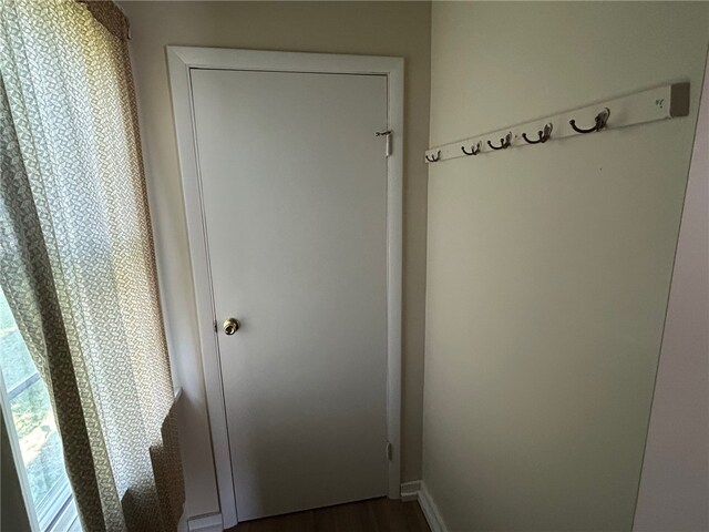 472 Seneca Rd, Irondequoit, NY 14622 - hallway featuring baseboards and dark wood finished floors