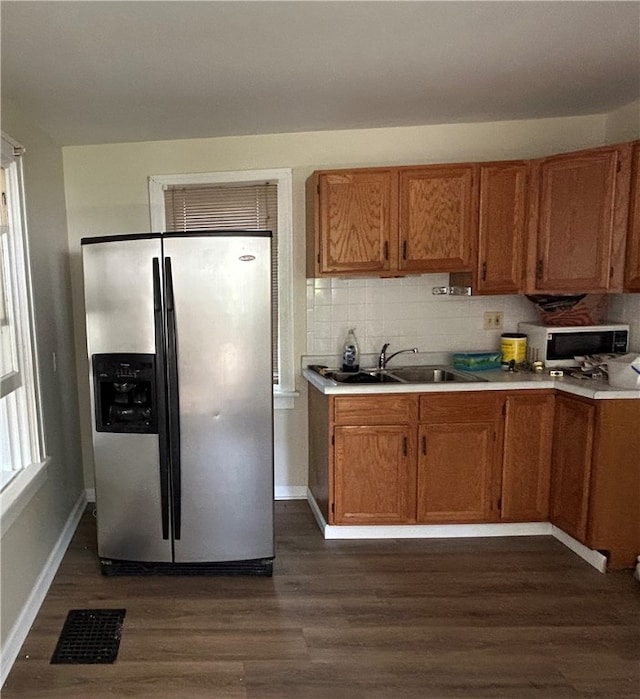 472 Seneca Rd, Irondequoit, NY 14622 - kitchen with stainless steel appliances, dark wood-style flooring, and brown cabinetry