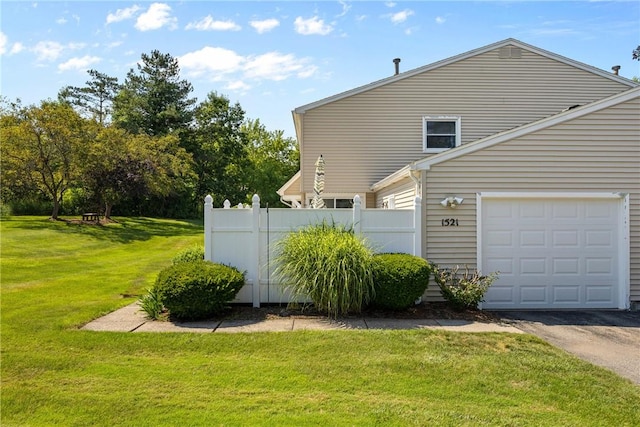 1521 Aster Ter, Walworth, NY 14568 - view of side of home featuring a garage and asphalt driveway