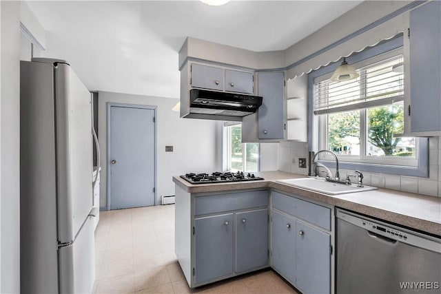 566 Adam St, Tonawanda, NY 14150 - kitchen featuring freestanding refrigerator, dishwasher, under cabinet range hood, gas stovetop, and decorative backsplash