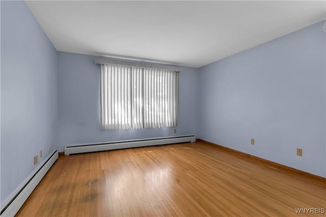 566 Adam St, Tonawanda, NY 14150 - unfurnished room with a baseboard radiator and wood-type flooring