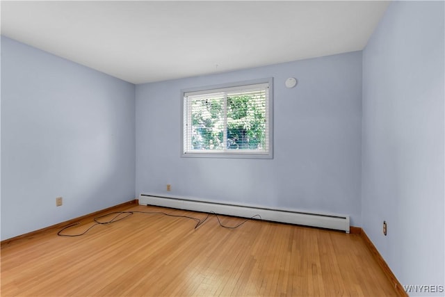566 Adam St, Tonawanda, NY 14150 - empty room with a baseboard radiator and wood finished floors