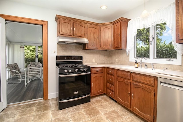 23 Hathaway Rd, Irondequoit, NY 14617 - kitchen featuring black range with gas stovetop, under cabinet range hood, dishwasher, light countertops, and brown cabinets