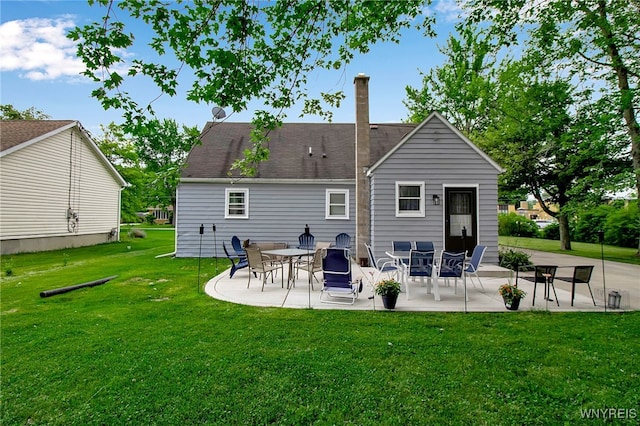 3029 Stieg Rd, Wheatfield, NY 14120 - rear view of house featuring a patio area, a yard, and a chimney
