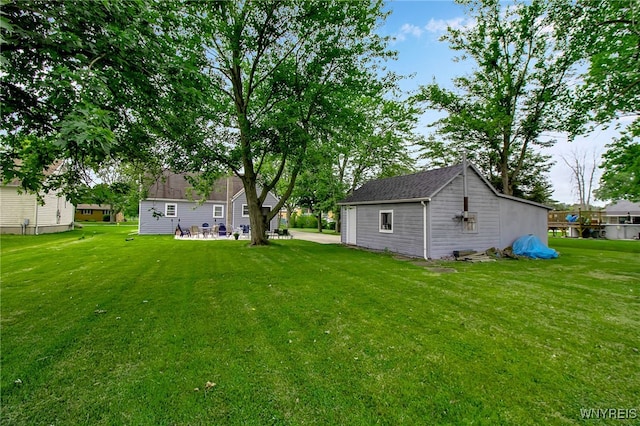 3029 Stieg Rd, Wheatfield, NY 14120 - view of green lawn featuring a patio area and an outbuilding