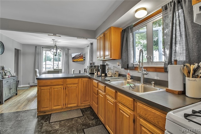 3029 Stieg Rd, Wheatfield, NY 14120 - kitchen with healthy amount of natural light, a peninsula, dark countertops, and brown cabinetry