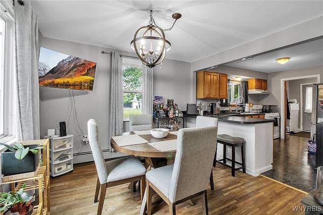 3029 Stieg Rd, Wheatfield, NY 14120 - dining room with a chandelier and dark wood finished floors