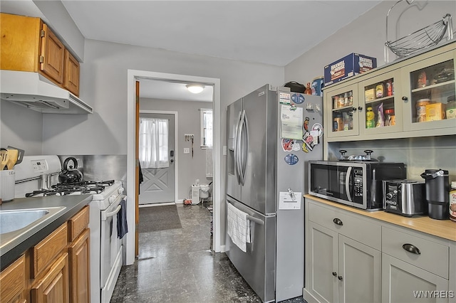 3029 Stieg Rd, Wheatfield, NY 14120 - kitchen with white gas range, under cabinet range hood, stainless steel fridge with ice dispenser, glass insert cabinets, and brown cabinetry