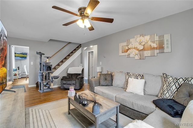 3029 Stieg Rd, Wheatfield, NY 14120 - living area with stairway, light wood-style floors, and a ceiling fan