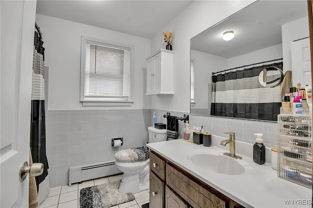 3029 Stieg Rd, Wheatfield, NY 14120 - bathroom featuring a baseboard radiator, tile patterned flooring, tile walls, vanity, and wainscoting
