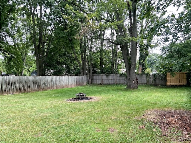 9 Curtis Ave, Lysander, NY 13027 - fenced backyard with an outdoor fire pit