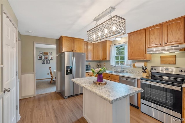 22 Tree Line Dr, Clay, NY 13090 - kitchen featuring appliances with stainless steel finishes, under cabinet range hood, light wood-style floors, and a center island