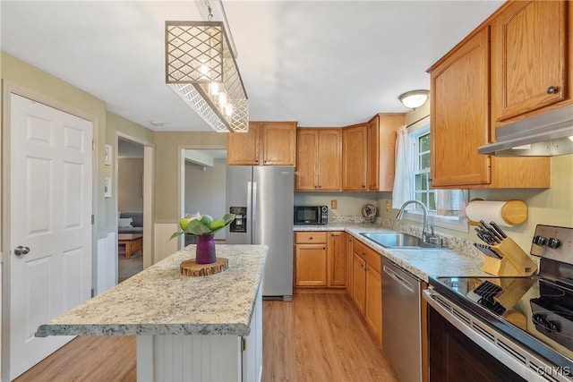22 Tree Line Dr, Clay, NY 13090 - kitchen with stainless steel appliances, light wood-style flooring, under cabinet range hood, a kitchen island, and pendant lighting