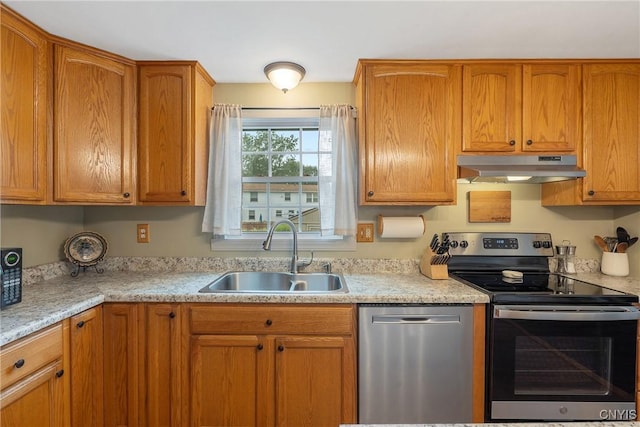 22 Tree Line Dr, Clay, NY 13090 - kitchen with under cabinet range hood, stainless steel appliances, and brown cabinetry