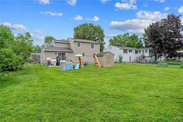 22 Tree Line Dr, Clay, NY 13090 - back of property with a storage shed, a fenced backyard, and a chimney