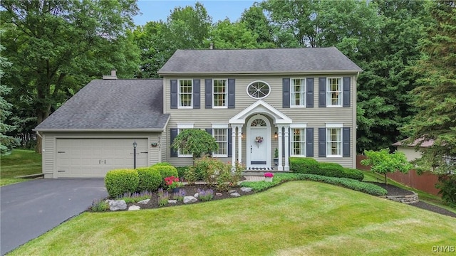 9607 Dunderry, Lysander, NY 13027 - colonial-style house featuring driveway, an attached garage, and a front lawn