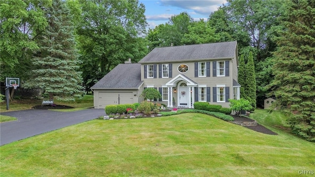 9607 Dunderry, Lysander, NY 13027 - colonial house with asphalt driveway, an attached garage, and a front lawn