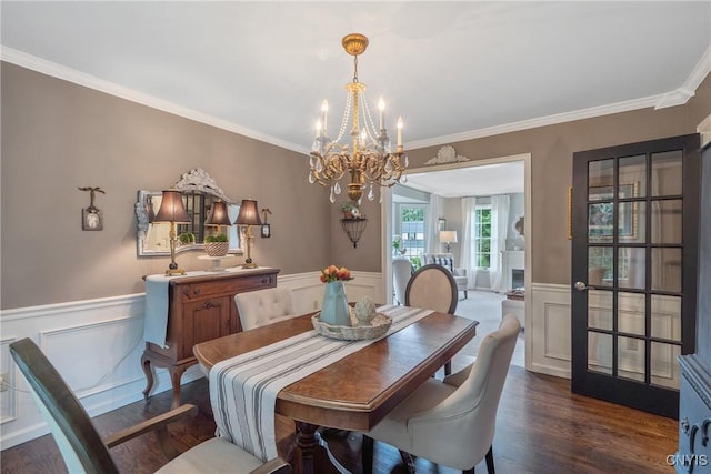 9607 Dunderry, Lysander, NY 13027 - dining space with a chandelier, wainscoting, wood finished floors, a decorative wall, and crown molding