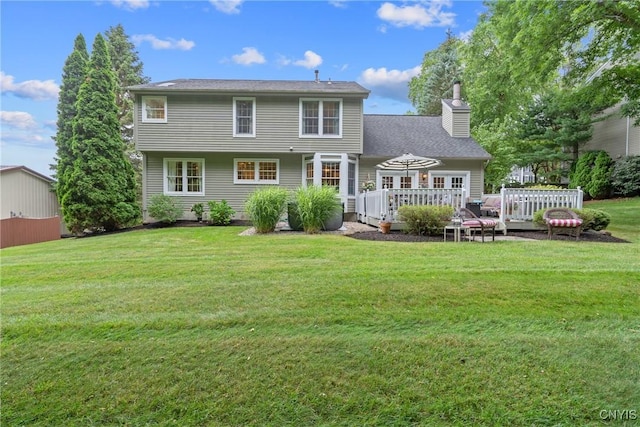 9607 Dunderry, Lysander, NY 13027 - rear view of house featuring a chimney, a wooden deck, and a lawn