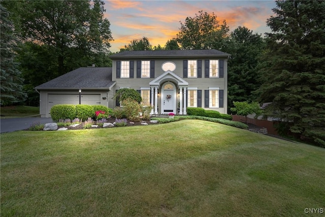 9607 Dunderry, Lysander, NY 13027 - colonial house featuring a yard, driveway, and a garage